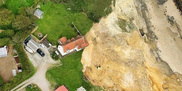 Shocking photos show 18th century house dangling off edge of cliff